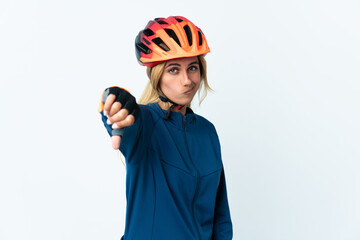 Young blonde Uruguayan cyclist woman isolated on background showing thumb down with negative expression