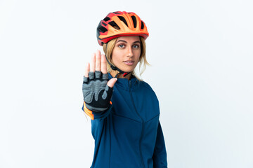 Young blonde Uruguayan cyclist woman isolated on background making stop gesture