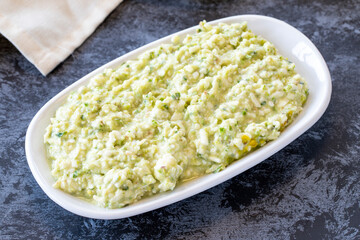 An appetizer prepared with feta cheese and pistachios. Traditional Turkish and Arabic cuisine meze. Snack meal served alongside the main course. Natural vegetarian food. Local name grit ezmesi mezze