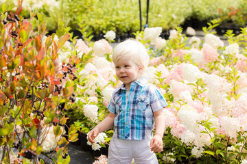 Cute blonde boy outdoor at botanical garden