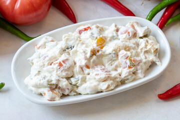 Panco appetizer prepared with potatoes, yogurt and peppers. Traditional Turkish and Arabic cuisine meze. Snack meal served alongside the main course. Natural vegetarian food. Local name Panco mezze