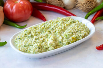 An appetizer prepared with feta cheese and pistachios. Traditional Turkish and Arabic cuisine meze. Snack meal served alongside the main course. Natural vegetarian food. Local name grit ezmesi mezze