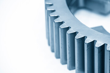 Close-up scene of pinion gear part in the light blue scene. The automotive part manufacturing concept.