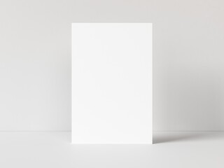 One blank vertical rectangle poster template standing on white table with white background. 3D illustration
