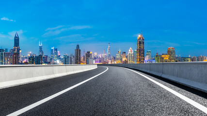 Fototapeta na wymiar Empty asphalt road and city skyline with buildings at night in Shanghai.