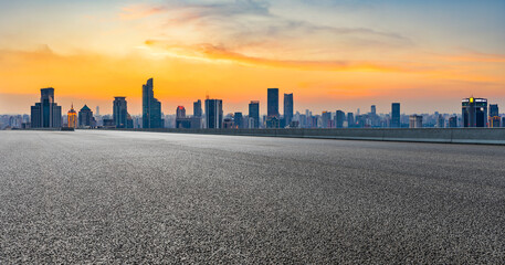 Fototapeta na wymiar Empty asphalt road and city skyline with buildings at sunset in Shanghai.