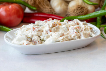 Panco appetizer prepared with potatoes, yogurt and peppers. Traditional Turkish and Arabic cuisine meze. Snack meal served alongside the main course. Natural vegetarian food. Local name Panco mezze