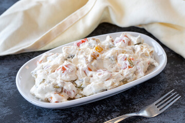 Panco appetizer prepared with potatoes, yogurt and peppers. Traditional Turkish and Arabic cuisine meze. Snack meal served alongside the main course. Natural vegetarian food. Local name Panco mezze