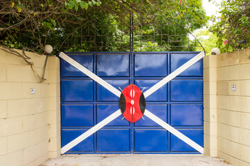 Iron gate with a white cross