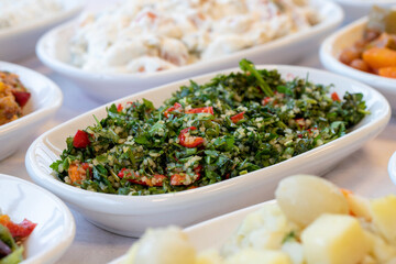 Tabboule appetizer. Traditional Turkish and Arabic cuisine meze. Snack meal served alongside the main course. Natural vegetarian food. Bulk appetizer plates. Local name taboule mezze.