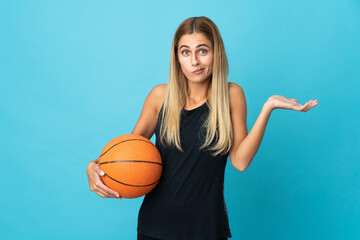 Young woman playing basketball  isolated on white background having doubts while raising hands