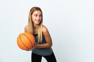 Young student woman isolated on white background playing basketball