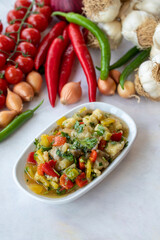 Anamur salad appetizer prepared with many vegetables. Traditional Middle Eastern appetizers with the main course. Layout on white wood