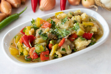 Anamur salad appetizer prepared with many vegetables. Traditional Middle Eastern appetizers with the main course. Layout on white wood