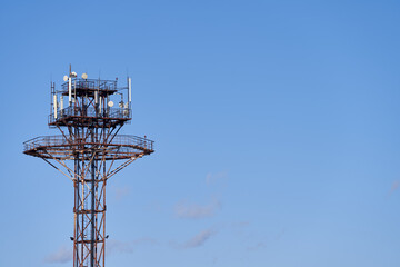 Cellular radio tower, antenna for communication of mobile phones against the background of a clear sky. Close-up with copy space.