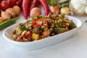 Healthy vegetarian food, traditional flavor Gavurdagi Salad with walnut. coban or choban salad. Mezze served alongside the main course. Appetizer