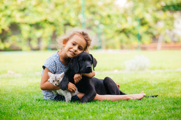 Pets giving their love to small children - 418952443