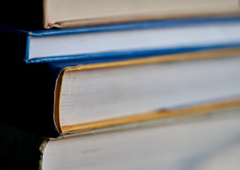 a stack of books and glasses are on the table