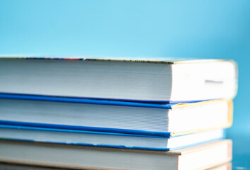 a stack of books and glasses are on the table