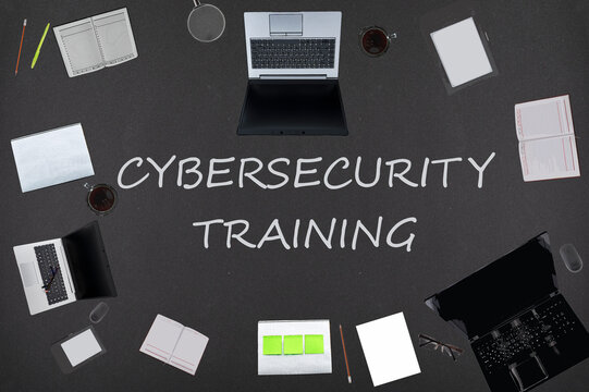 Cybersecurity training concept. Top layout of drawings of laptops, notepads, coffee, different business stuff on black background.