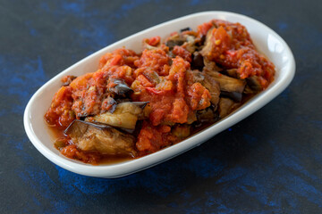 Grilled eggplant salad appetizer with tomato sauce (with eggplant sauce or saksuka). Traditional Middle Eastern meze beside the main course.