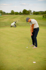 Fototapeta premium Young man playing golf