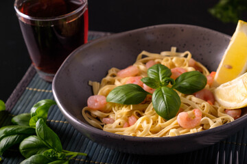 Pasta with shrimps, basil and tomatoes