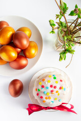 Sweet Easter cake panettone with icing and golden eggs.