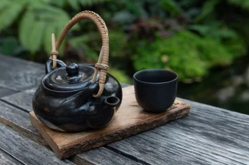 Foto op Aluminium Black Japanese tea cup on wooden background, © Thiradech