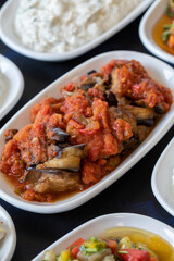 Traditional Turkish and Greek food appetizer table. Grilled eggplant salad (saksuka), Anamur salad, Baba Ghanoush (Mutabbal), pasha appetizer, spicy paste or harissa, purslane salad. Selective focus