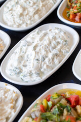 Traditional Turkish and Greek food appetizer table. Grilled eggplant salad (saksuka), Anamur salad, Baba Ghanoush (Mutabbal), pasha appetizer, spicy paste or harissa, purslane salad. Selective focus