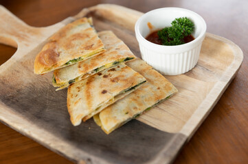 Crispy pizza on wooden plates with sauce cups