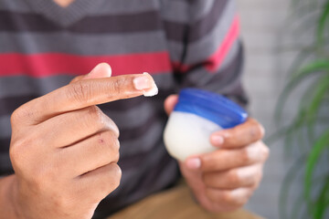  Close up of man hand using petroleum jelly 