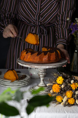 homemade carrot cake with chocolate and slice on the table