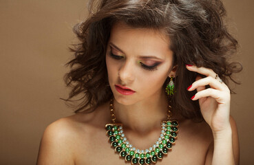 Obraz premium Beautiful woman with long wavy hair . Brunette with curly hairstyle.