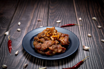 Low light photography of Pork fried with garlic ready for serve