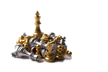 Gold and silver team fighting on white background. a gold king wins the match. chess pieces isolated on white background
