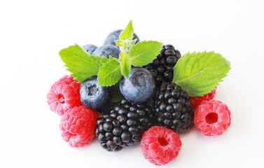 Mix berries with leaf. Various fresh berries isolated on white background. Raspberry, Blueberry, Cranberry, Blackberry and Mint leaves