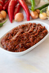 Spicy pastry appetizer (harissa) made with tomato, pepper, garlic, onion, pepper paste and olive oil. Acılı ezme. adjika