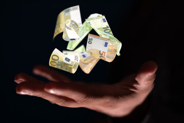 capital euro banknote in hand rain