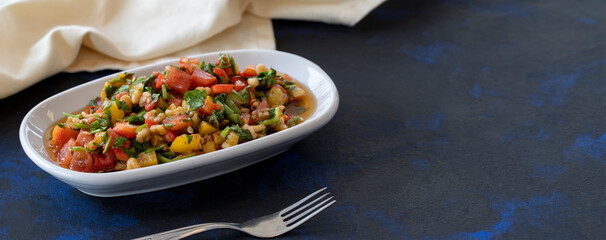 Healthy vegetarian food, traditional flavor Gavurdagi Salad with walnut. coban or choban salad. Mezze served alongside the main course. Appetizer