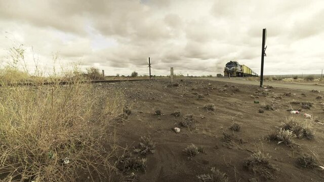 TransNamib Freight Train Crossing Arid Wasteland Of Namibia Woodlands - Ground Level Wide Static Shot