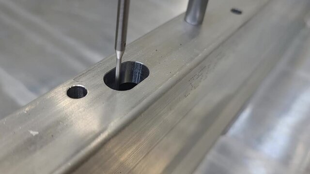 CMM coordinate measuring machine - checking the size and location of a slot on a machined aluminum part close up stationary camera