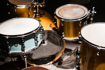 Closeup professional musical instrument. Drum kit for jazz band in recording studio. Drumsticks lying on drum. Drum set with drum cymbals.