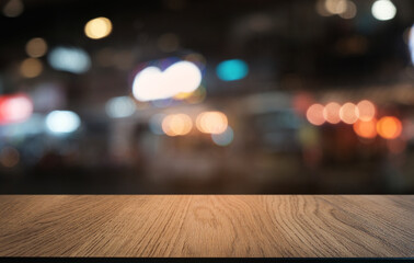 Empty dark wooden table in front of abstract blurred bokeh background of restaurant . can be used for display or montage your products.Mock up for space.