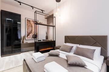 Interior photography, modern bedroom, with large stylish bed, modern design, in beige