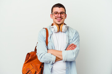 Young caucasian student man listening to music isolated on white background who feels confident, crossing arms with determination.