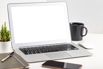 Fototapeta premium White desk office with laptop, smartphone and other work supplies with cup of coffee. Designer workspace on desk table essential elements on flat lay