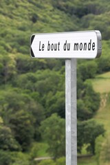 Road sign the end of the world called le bout du monde in french language