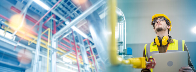 Professional male engineer wearing uniform and safety helmet  inspection and checking production...